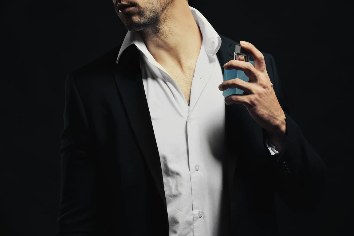 Young Man Using Perfume